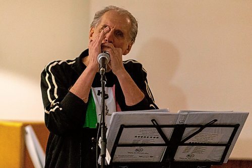 Daniel Crump / Winnipeg Free Press. Fred Dugdale, of the Celtic band Killick, plays harmonica during soundcheck before a set at the Irish Association of Manitoba club in Winnipeg. February 12, 2022.