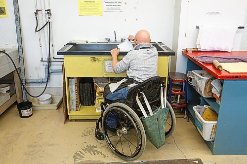 MIKE DEAL / WINNIPEG FREE PRESS
Ted Howorth is a printmaker and wheelchair user who was involved in the consultation process for an arts venue audit created by the Arts Accessibility Network Manitoba. The audit aims to give venue operators ways to make their space more accessible for patrons and artists with disabilities.
At the Martha Street Studio, Ted, works on printing one of his mezzotint plates Monday afternoon. The printing studio is in the basement of the building and requires him to use an elevator to gain access. The majority of the equipment is already somewhat accessible to him with only the odd item that is requires a bit more effort to access.
See Eva Wasney story
220214 - Monday, February 14, 2022.