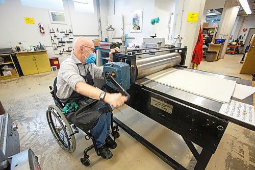 MIKE DEAL / WINNIPEG FREE PRESS
Ted Howorth is a printmaker and wheelchair user who was involved in the consultation process for an arts venue audit created by the Arts Accessibility Network Manitoba. The audit aims to give venue operators ways to make their space more accessible for patrons and artists with disabilities.
At the Martha Street Studio, Ted, works on printing one of his mezzotint plates Monday afternoon. The printing studio is in the basement of the building and requires him to use an elevator to gain access. The majority of the equipment is already somewhat accessible to him with only the odd item that is requires a bit more effort to access.
See Eva Wasney story
220214 - Monday, February 14, 2022.