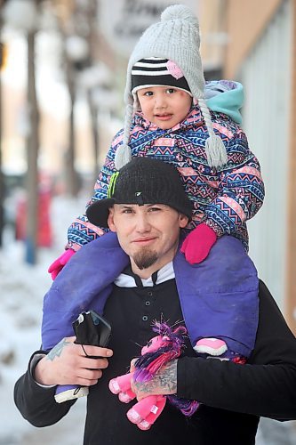 14022021
Derek Baker gives his three-year-old daughter Keight a piggyback ride in downtown Brandon on Monday. (Tim Smith/The Brandon Sun)