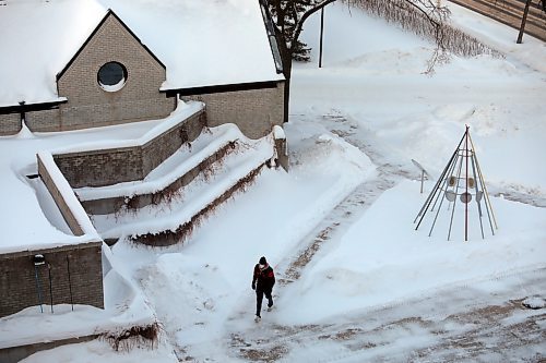 A pedestrian walks across the Brandon University campus on a cold Wednesday afternoon in January. (Tim Smith/The Brandon Sun)