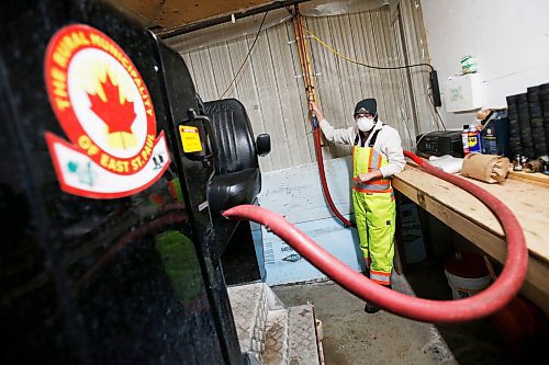 JOHN WOODS / WINNIPEG FREE PRESS
Taylor Brandt, recreation facility operator at East St Paul Community Centre, fills the ice resurfacer in the indoor rink at the community centre Monday, February 14, 2022. Brandt has been driving an ice resurfacer for the past year. Brandt also does landscaping at the centre during the summer months.

Re: Small