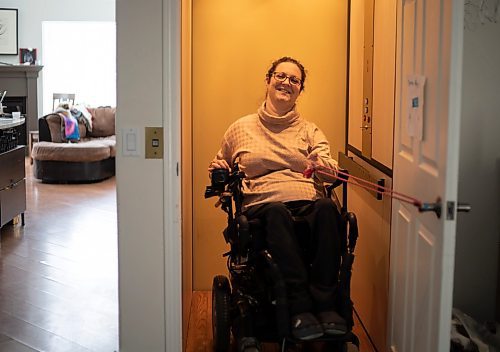 JESSICA LEE / WINNIPEG FREE PRESS

Yvette Cenerini, a digital collage maker and a wheelchair user, is photographed using the elevator at her home on February 15, 2022.

Reporter: Eva

