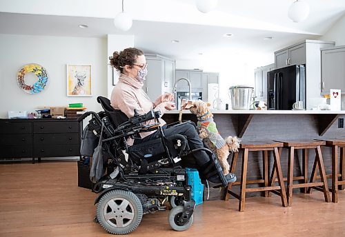 JESSICA LEE / WINNIPEG FREE PRESS

Yvette Cenerini, a digital collage maker and a wheelchair user, is photographed at her home with her dog Jasper on February 15, 2022, in St. Boniface.

Reporter: Eva

