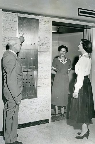 WINNIPEG FREE PRESS ARCHIVES

Five new automatic, electronic elevators will begin operating at the T. Eaton Co. department store Thursday. Here J. O. Sutherland, chief elevator inspector, shows Mrs. M. Burton, sales clerk, the indicator panel which flashes floor numbers as the car moves up and down. Miss Joyce Richards, elevator operator, smiles happily in her new &quot;push-button&quot; car.
1958