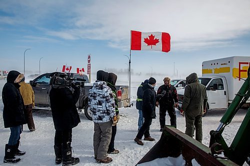 MIKE DEAL / WINNIPEG FREE PRESS
Protesters stand infant of a camera person while a reporter tries to talk to a trucker blocking the border crossing at Emerson, MB.
220216 - Wednesday, February 16, 2022.
