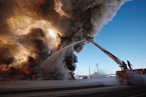 17022022
Brandon Fire and Emergency Services members battle a large fire that destroyed an apartment complex under construction on Victoria Avenue and 42nd Street in Brandon on a bitterly cold Thursday morning. Smoke from the blaze could be seen from across the city as it towered up into the clear sky. (Tim Smith/The Brandon Sun)