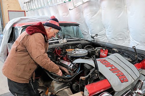 Lothar Weber tunes up his 1957 Ford Fairlane Skyliner on Wednesday morning in Westman. The 74-year-old told the Sun that he finally tracked this rare retractable car down in 2012 after looking for it for most of his adult life. (Kyle Darbyson/The Brandon Sun)