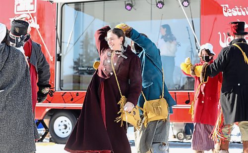 RUTH BONNEVILLE / WINNIPEG FREE PRESS

 LOCAL / ENT - FdV

Musicians play inside the music box as members of the official festival family, THE TURENNE FAMILY, dance in front of it during the launch of the 2022 festival on Thursday. 

The Festival du Voyageur unveils its Music Box, the Boite de chansons at Whittier Park. At the festival kickoff presser, musicians played inside the music box, which is a trailer that has a band inside separated by glass, to perform for the audience outside. It's partially a COVID-19 protection shield, but also helps when it's cold because band can have electronic difficulty in cold weather. 

See Small story. 

Feb 17th, 2022