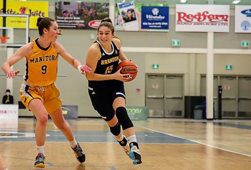 Brandon University Bobcats Adrianna Proulx races past the University of Manitoba Bisons Autumn Agar in a Canada West women&#x573; basketball game at the Healthy Living Centre Friday. (Chelsea Kemp/The Brandon Sun)