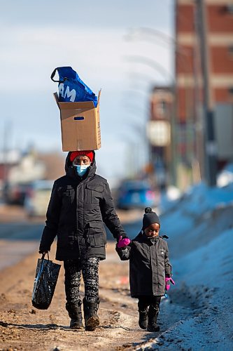 A women and her child walk down Pacific Avenue Wednesday. (Chelsea Kemp/The Brandon Sun)