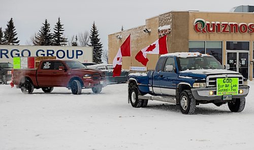Ralliers participate in a slow-roll truck convoy for freedom in Brandon Saturday. The protest was in support of truckers in Ottawa pushing for the end of COVID-19 related mandates. The group of several dozen vehicles, including semis, departed from the north hill Tim Hortons and ended at the Victoria Inn parking lot &#x2014; it was originally scheduled to drive down to Portage la Prairie but was re-rooted due to poor road conditions. (Chelsea Kemp/The Brandon Sun)