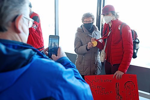 22022022
Local Olympian Kristen Campbell takes photos at the Brandon Municipal Airport with her grandmother Elaine Campbell along with her gold medal that she won as part of Team Canada's women's hockey team at the Olympic Games Beijing 2022. 
(Tim Smith/The Brandon Sun)