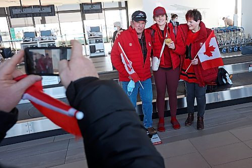 22022022
Local Olympian Kristen Campbell takes photos at the Brandon Municipal Airport with her parents Brent and Janet as well as her gold medal that she won as part of Team Canada's women's hockey team at the Olympic Games Beijing 2022. 
(Tim Smith/The Brandon Sun)