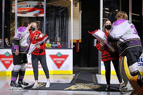 23022022
Canadian Olympic gold medalists Ashton Bell and Kristen Campbell are presented with flowers by Nolan Ritchie and Ethan Kruger of the Brandon Wheat Kings prior to the Wheaties WHL match against the Saskatoon Blades at Westoba Place on Wednesday evening. Bell and Campbell were part of the Team Canada's gold medal winning women's hockey team at the recent 2022 Beijing Olympic Games. (Tim Smith/The Brandon Sun)