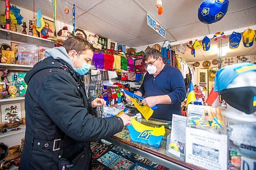 MIKAELA MACKENZIE / WINNIPEG FREE PRESS

Svitoch Ukrainian Export &amp; Import owner Ruslan Zeleniuk (right) packs up flags for Alexey, who has family in the Luhansk region, in Winnipeg on Thursday, Feb. 24, 2022. For Erik story.
Winnipeg Free Press 2022.