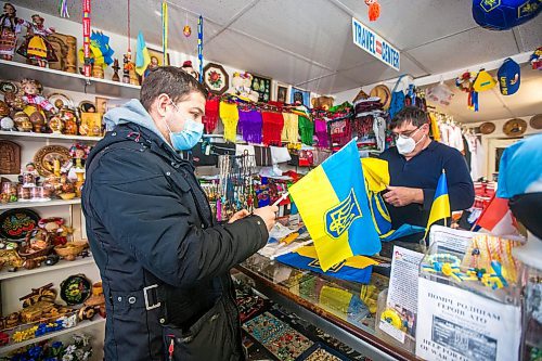 MIKAELA MACKENZIE / WINNIPEG FREE PRESS

Svitoch Ukrainian Export &amp; Import owner Ruslan Zeleniuk (right) packs up flags for Alexey, who has family in the Luhansk region, in Winnipeg on Thursday, Feb. 24, 2022. For Erik story.
Winnipeg Free Press 2022.