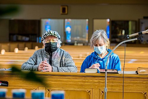 MIKAELA MACKENZIE / WINNIPEG FREE PRESS

Mother and daughter parishioners Rose (left) and Diana Olynyk pray for the Ukraine at St. Basil's Ukrainian Catholic Church in Winnipeg on Thursday, Feb. 24, 2022. For Erik story.
Winnipeg Free Press 2022.