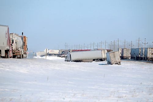 24022022
Semi trailers rest in the median between the westbound and eastbound lanes of the Trans Canada Highway east of Griswold, Manitoba as other backed up vehicles wait to pass the scene of a major collision involving approximately two dozens vehicles on the highway on Thursday. The extremely icy conditions caused several vehicles to go off the road on the Trans Canada Highway around Griswold in addition to the several vehicle collision. (Tim Smith/The Brandon Sun)