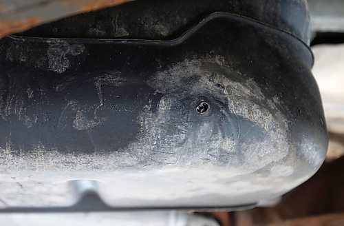 JOHN WOODS / WINNIPEG FREE PRESS
A gas tank of a vehicle at Little People&#x2019;s Place Daycare vans which was drilled and the gas stolen is photographed outside the daycare Tuesday, March 8, 2022. The childcare staff discovered that the gas tanks of their three vehicles were drilled and drained.