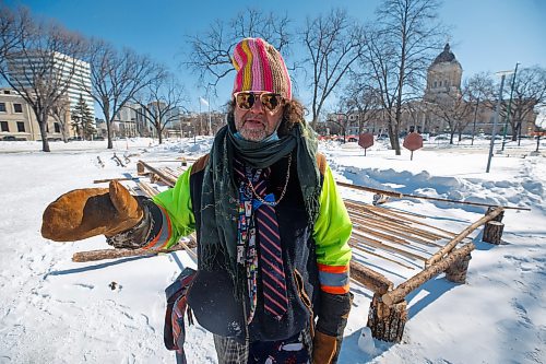 MIKE DEAL / WINNIPEG FREE PRESS
A gentleman going by the name, Mountain Goat, talks about what structures were removed at the peace camp he volunteers at on Memorial Park.
The people at the two peace camps that have been on the grounds of the Manitoba Legislative building were confronted by Provincial Security officers around 7 a.m. Wednesday morning. The officers had bulldozers with them and they dismantled structures on both camps only stopping when occupiers were forced to throw themselves in front of the heavy machinery.
One of the camps which has had a sacred fire burning for almost a year on the east side of the building had several of their tents destroyed including their kitchen which held donated foods for the fire keepers. The other camp in Memorial Park, which has been around since September, but grew larger during the convoy protest had a few structures bulldozed and removed.
See Codey Sellar story
220309 - Wednesday, March 09, 2022.