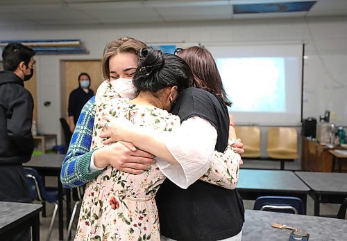 RUTH BONNEVILLE / WINNIPEG FREE PRESS

Local - Fort Richmond helps dad in Ukraine

Karen Robb (EA at Fort Richmond Collegiate, shares a hug with her students in her class.  Moments earlier the was shocked when she got an unexpectant call from her birth father, Gary Milani Wednesday, after he arrived safely in Krakow Poland with the help of her students. Robb was with her grade 12 Fort Richmond Collegiate students getting a photo for the Free Press when the call came in Wednesday afternoon.  

The media were interviewing her and her students because her birth father was provided and escape route and a map from FRC students on the safest way to escape the Ukraine and get to Poland (map is on the overhead wall behind them).  

See story by Maggie Macintosh

Names:
Karen Robb (EA)
Adil Hayat (Floral shirt, G12)
Divya Sharma (Centre, G12)
Inga Kseniia Tkaschuk (Plaid shirt, G12)

March 9th,  2022
