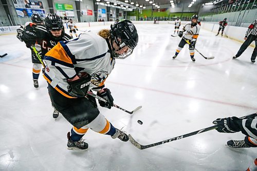 Daniel Crump / Winnipeg Free Press. A J. H Bruns player battle for the puck in the corner against several CSLR players. J.H. Burns plays CSLR in a women&#x573; high school hockey semi-final. At Southdale Community Centre in Winnipeg. March 9, 2022.