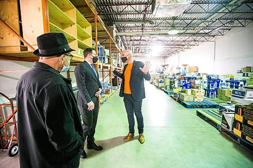 MIKAELA MACKENZIE / WINNIPEG FREE PRESS

Federal Public Safety Minister Marco Mendicino (centre) gets a tour of the warehouse, which houses liquor that has sat there for a couple of years, with Emerson Duty Free owner Simon Resch (right) and co-owner/dad Michael Resch during the minister's visit to Emerson on Thursday, March 10, 2022. For Gabby story.
Winnipeg Free Press 2022.