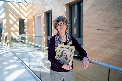 On March 10, 2022, Thora Cartlidge stands for a portrait with a photo of her late mother, Mary Cartlidge, who passed away from Covid-19.  The Winnipeg Free Press / David Jackson 