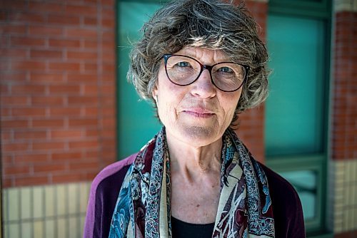 On March 10, 2022, Thora Cartlidge stands for a portrait with a photo of her late mother, Mary Cartlidge, who passed away from Covid-19.  The Winnipeg Free Press / David Jackson 