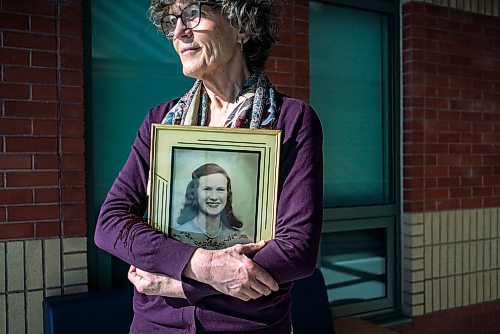 On March 10, 2022, Thora Cartlidge stands for a portrait with a photo of her late mother, Mary Cartlidge, who passed away from Covid-19.  The Winnipeg Free Press / David Jackson 