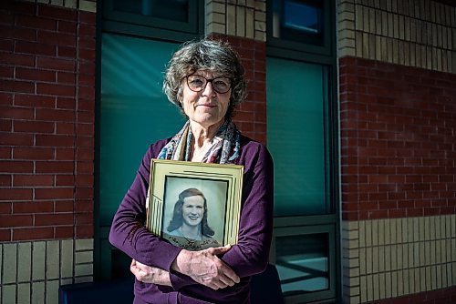 On March 10, 2022, Thora Cartlidge stands for a portrait with a photo of her late mother, Mary Cartlidge, who passed away from Covid-19.  The Winnipeg Free Press / David Jackson 