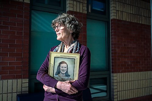 On March 10, 2022, Thora Cartlidge stands for a portrait with a photo of her late mother, Mary Cartlidge, who passed away from Covid-19.  The Winnipeg Free Press / David Jackson 