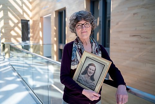 On March 10, 2022, Thora Cartlidge stands for a portrait with a photo of her late mother, Mary Cartlidge, who passed away from Covid-19.  The Winnipeg Free Press / David Jackson 