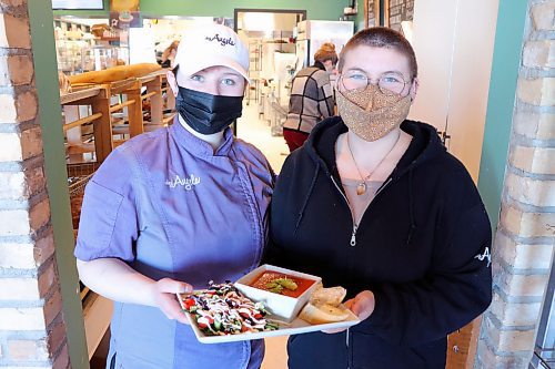 Chez Angela Bakery and Caf&#xe9; employees Casey Naherniak and Kiara Schwarz serve up some tomato basil soup on Friday afternoon in downtown Brandon. The local restaurant staff have signed up to take part in the 2022 Stone Soup fundraiser, which is being expanded to include communities outside of Winnipeg this year. (Kyle Darbyson/The Brandon Sun) 