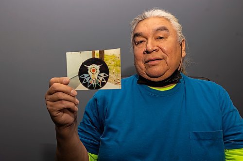 Sioux Valley Dakota Nation artist Roland Ironman hold a photo of a bison skull he painted Wednesday, March 2. (Chelsea Kemp/The Brandon Sun)