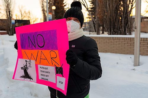 Aliona Fluerar holds a sign in support of Ukraine in front of Brandon City Hall Friday. Ukraine was invaded by Russian forces Thursday. (Chelsea Kemp/The Brandon Sun)