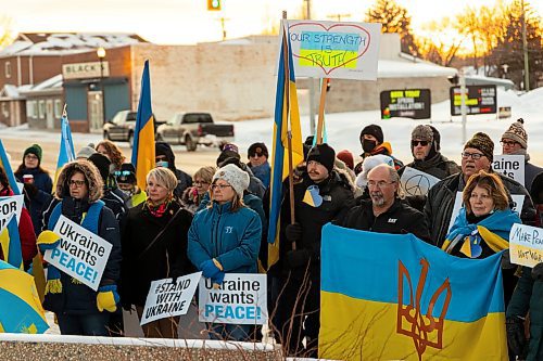 Community members gather for the Stand with Ukraine Rally in front of Dauphin City Hall Wednesday.(Chelsea Kemp/The Brandon Sun)