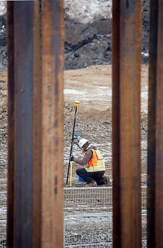 A surveyer at the construction site of the new Daly Overpass along 18th Street is seen here between steel girders that are being pounded into the earth. (Matt Goerzen/The Brandon Sun)