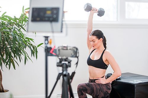 MIKAELA MACKENZIE / WINNIPEG FREE PRESS

Johanna Seier, founder of The Fit Girl Gang, demonstrates an exercise in the space where she filmed most of the workouts on the newly launched app in Winnipeg on Tuesday, March 15, 2022. For Gabby story.
Winnipeg Free Press 2022.