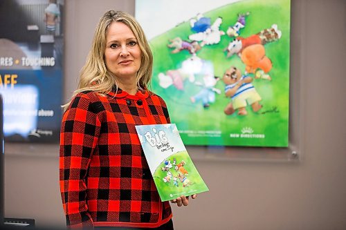 MIKAELA MACKENZIE / WINNIPEG FREE PRESS

Noni Classen, director of education for the Canadian Centre of Child Protection, poses for a portrait with a book that they've translated into Ukrainian to distribute to kids affected by the war on Tuesday, March 15, 2022. For Katie May story.
Winnipeg Free Press 2022.