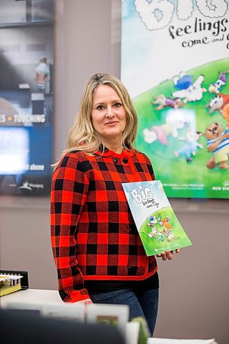 MIKAELA MACKENZIE / WINNIPEG FREE PRESS

Noni Classen, director of education for the Canadian Centre of Child Protection, poses for a portrait with a book that they've translated into Ukrainian to distribute to kids affected by the war on Tuesday, March 15, 2022. For Katie May story.
Winnipeg Free Press 2022.