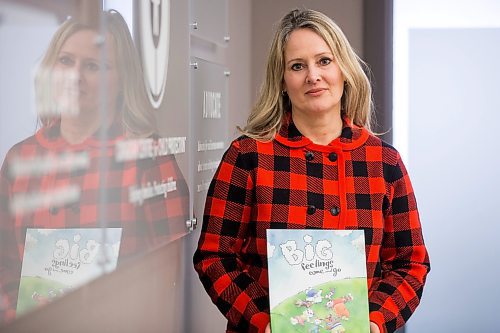 MIKAELA MACKENZIE / WINNIPEG FREE PRESS

Noni Classen, director of education for the Canadian Centre of Child Protection, poses for a portrait with a book that they've translated into Ukrainian to distribute to kids affected by the war on Tuesday, March 15, 2022. For Katie May story.
Winnipeg Free Press 2022.