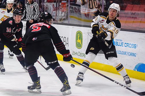 Brandon Wheat King Chad Nychuk whips the puck past Moose Jaw Warriors Calder Anderson, left, and Denton Mateychuk  in a Western Hockey League game Tuesday at Westoba Place. (Chelsea Kemp/The Brandon Sun)