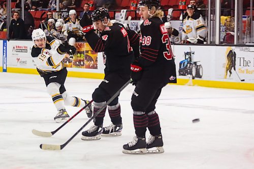 Brandon Wheat King Ridly Greig shoots the puck past Moose Jaw Warriors Martin Rysavy, left, and Ryder Korczak in a Western Hockey League game Tuesday at Westoba Place. (Chelsea Kemp/The Brandon Sun)