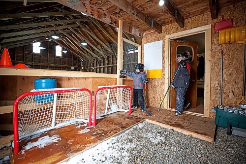 MIKE DEAL / WINNIPEG FREE PRESS
Matt Rawlings unlatches the door to the rink while his brother Sam exits the dressing room.
Dave Rawlings converted a barn on his property, with the help of his father Eric, into an indoor mini-skating rink. Including a heated change room. When the pandemic hit his kids, Sam and Matt, were able to skate almost everyday even during the worst lockdown stages.
See Ben Waldman story
220316 - Wednesday, March 16, 2022.
