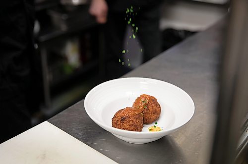 JESSICA LEE / WINNIPEG FREE PRESS

A chef sprinkles parsley on a small plate Arancini on March 15, 2022 at Little Nana&#x2019;s Italian Kitchen.

Reporter: Dave



