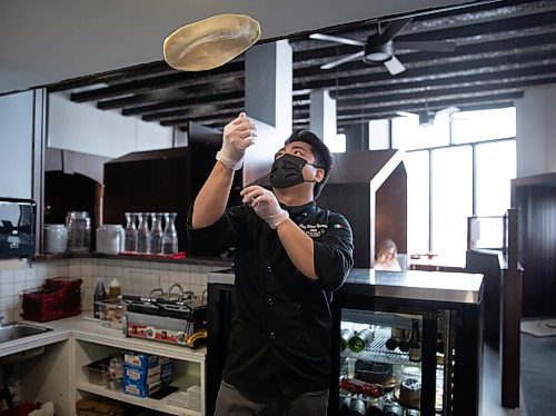 JESSICA LEE / WINNIPEG FREE PRESS

Chef Dann Carlo Ignacio tosses pizza dough in the air on March 15, 2022 at Little Nana&#x2019;s Italian Kitchen.

Reporter: Dave

