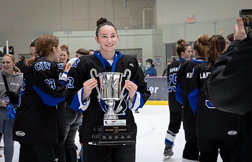 JESSICA LEE / WINNIPEG FREE PRESS

Coll&#xe8;ge Jeanne-Sauv&#xe9; player Rebecca Tessmer holds the trophy following the city finals game. CJS won the women&#x2019;s high school hockey championship against J.H. Bruns (3-0) on March 17, 2022 during the third finals game. 

Reporter: Taylor


