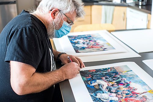 MIKAELA MACKENZIE / WINNIPEG FREE PRESS

Local artist Michael Boss, who is selling prints with proceeds going to the Ukrainian Red Cross, signs prints at the Martha Street Studio in Winnipeg on Friday, March 18, 2022.  For Alan Small story.
Winnipeg Free Press 2022.